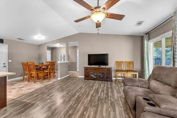 a living room with furniture and kitchen view