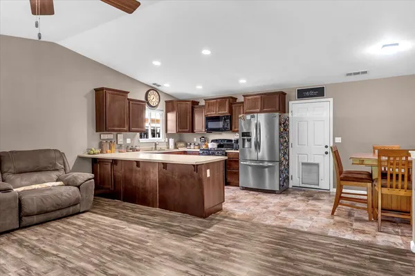 a kitchen with refrigerator and cabinets