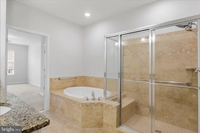 a bathroom with a tub and shower