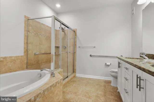 a bathroom with a tub sink toilet and a shower