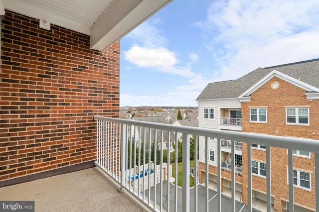 a view of a brick house with wooden fence