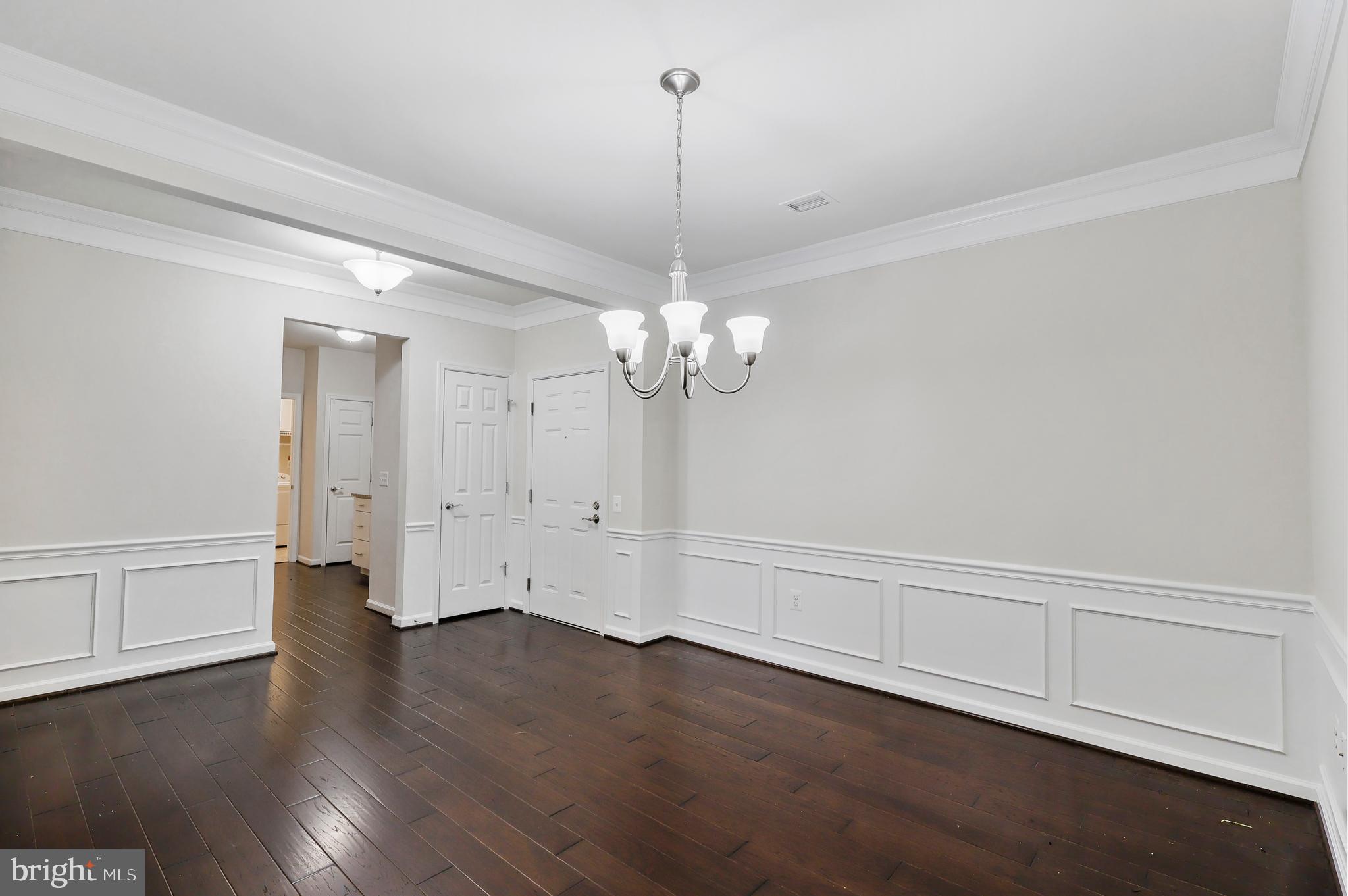 20655 Hope Spring Terrace, Unit 403 Ashburn, VA 20147 - Photo 3 of 21 a view of a room with wooden floor and ceiling fan