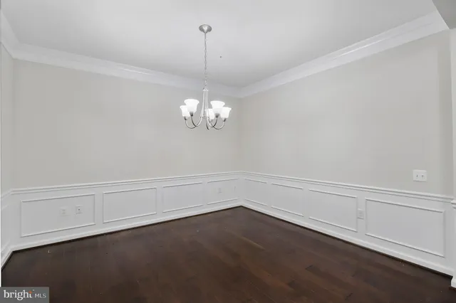 a view of a chandelier fan and wooden floor