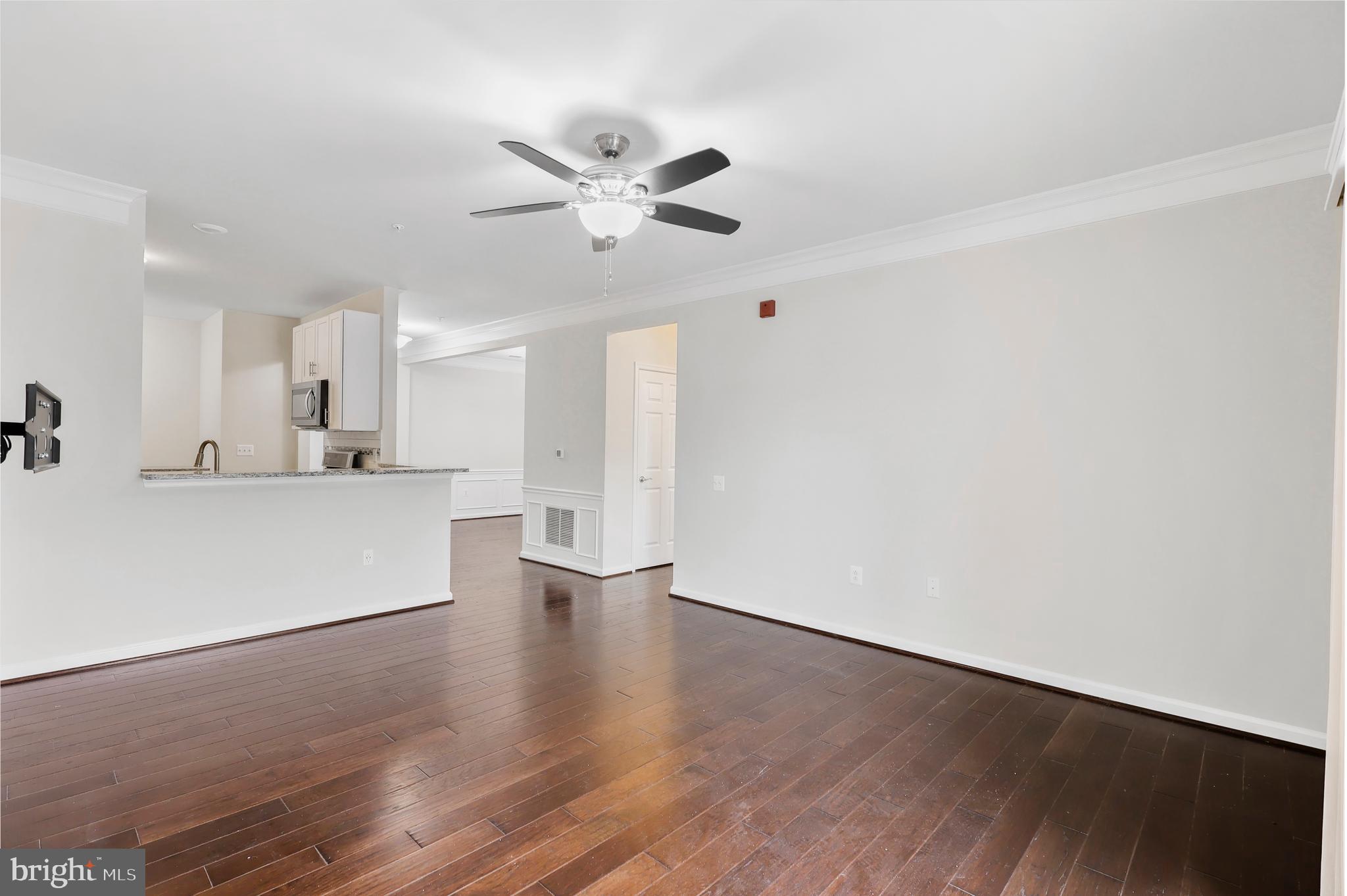 20655 Hope Spring Terrace, Unit 403 Ashburn, VA 20147 - Photo 5 of 21 a view of a kitchen with wooden floor and a sink