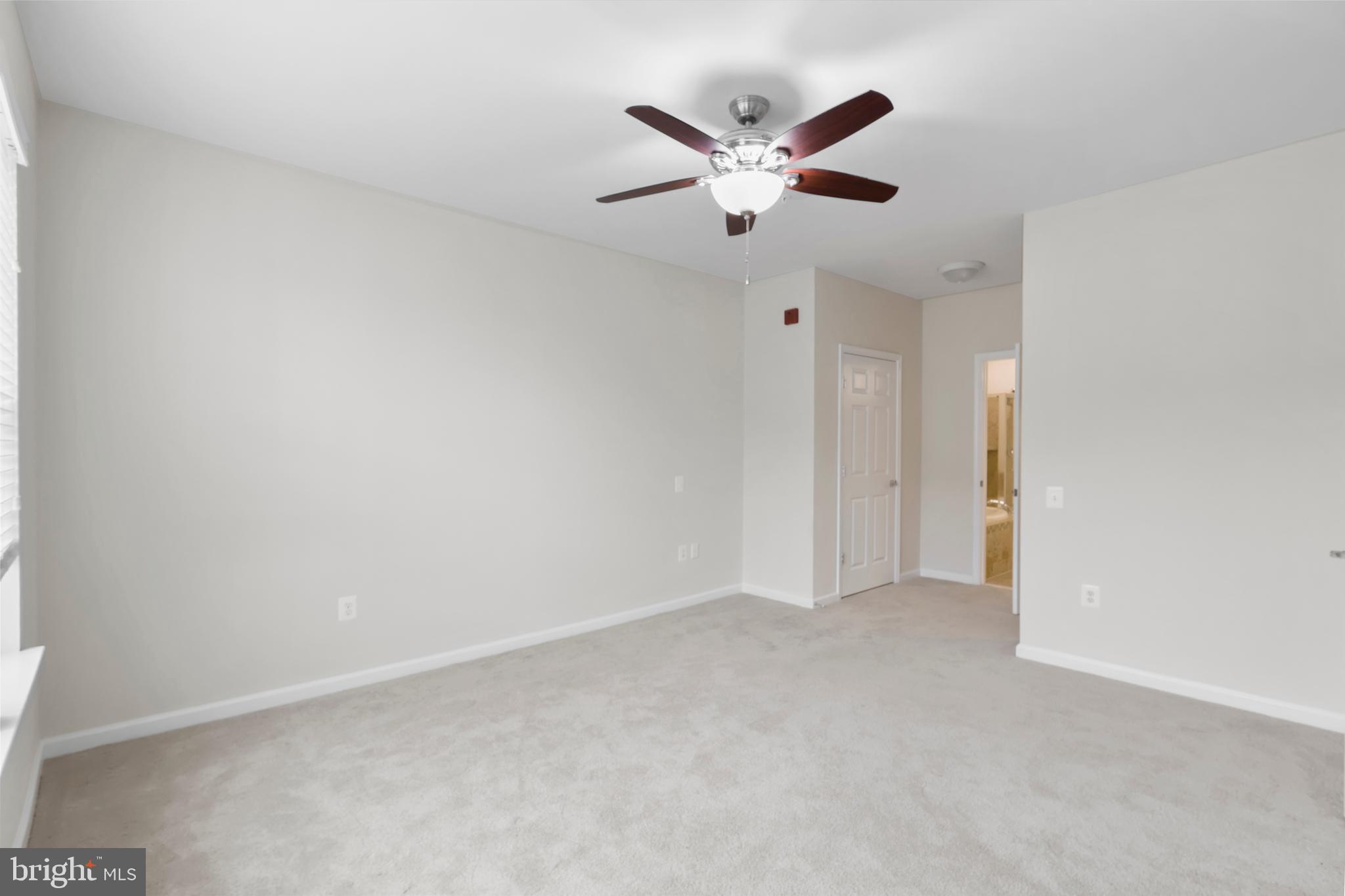 20655 Hope Spring Terrace, Unit 403 Ashburn, VA 20147 - Photo 10 of 21 an empty room with closet and a chandelier fan