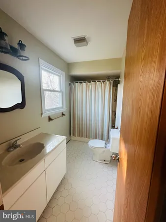 a bathroom with a sink a toilet and tub