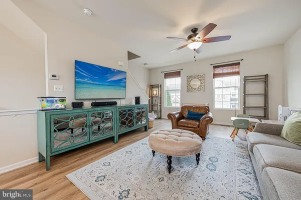 a living room with furniture a rug and a window