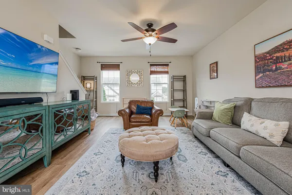 a living room with furniture a fireplace and a window