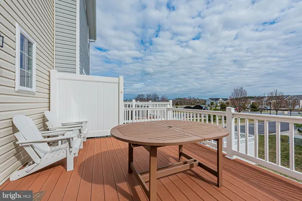 a view of a roof deck with table and chairs