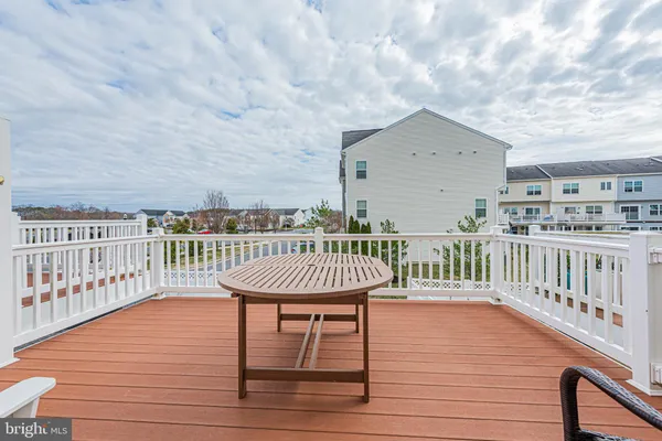 a balcony with furniture and wooden floor