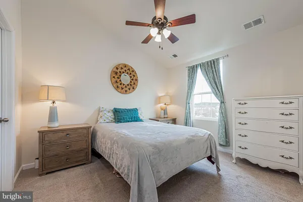 a bedroom with a bed a chandelier and a closet