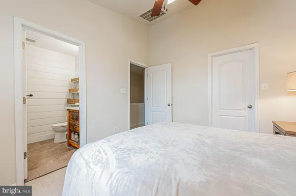 a bedroom with a bed and a large mirror