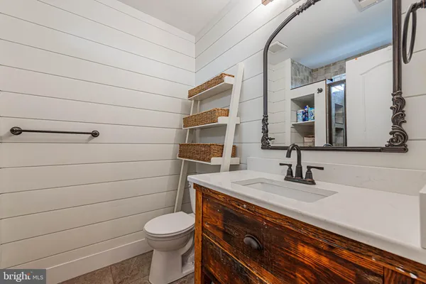 a bathroom with a toilet sink and mirror