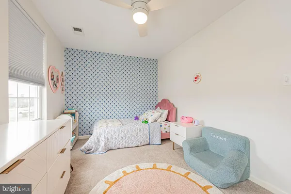 a bedroom with furniture and a large window