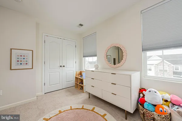 a en suite bathroom with a double vanity sink and a mirror