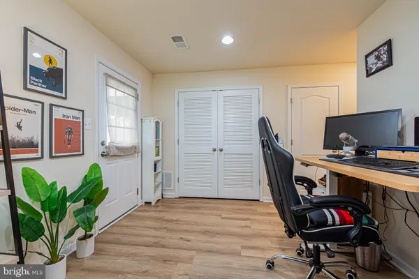 a view of a workspace with furniture and a potted plant