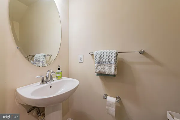 a bathroom with a sink a mirror and a toilet