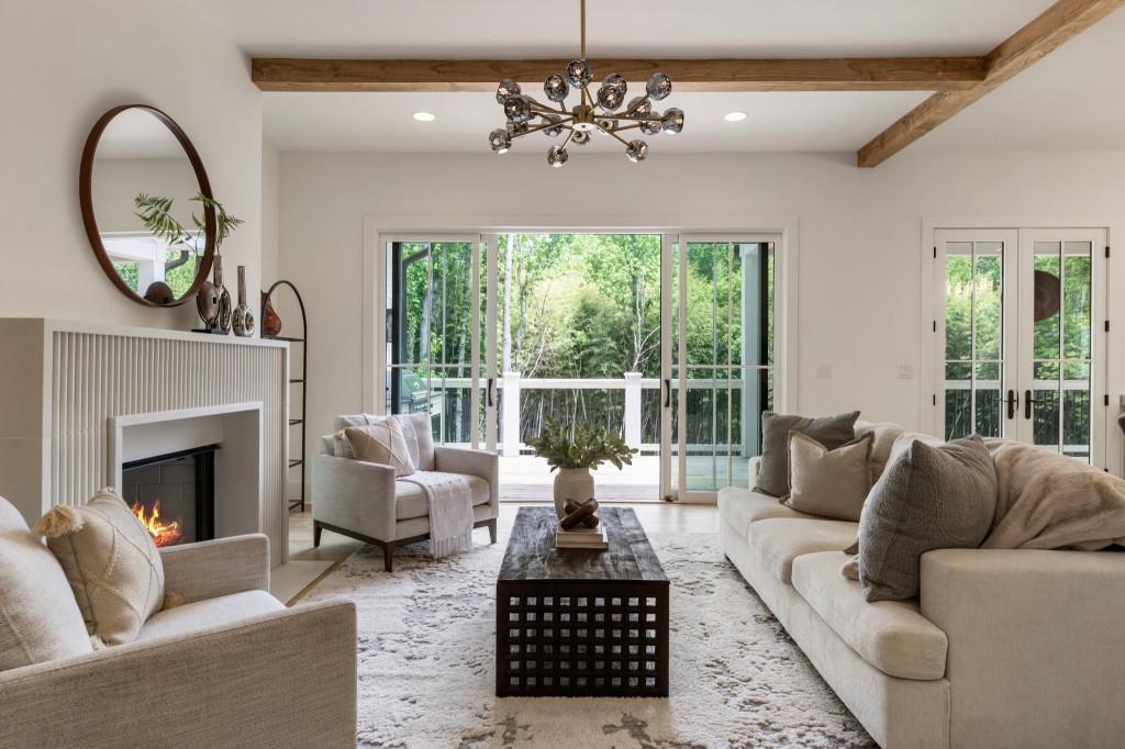 2000 Birmingham Road Milton, GA 30004 - Photo 16 of 42 a living room with furniture a fireplace and a chandelier