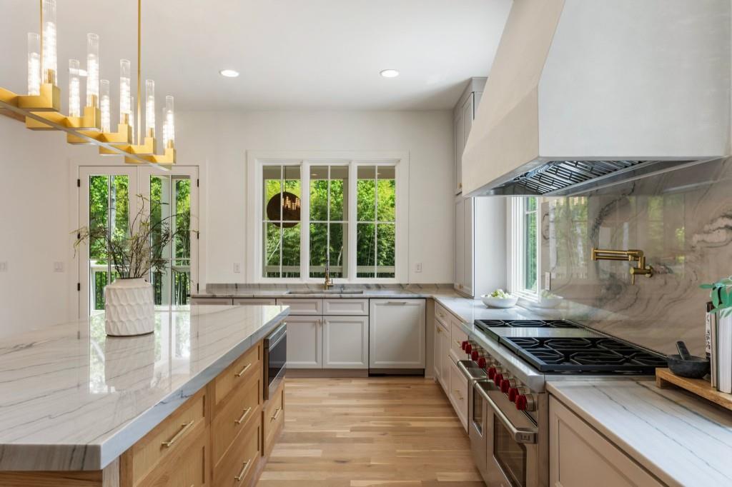 2000 Birmingham Road Milton, GA 30004 - Photo 21 of 42 a kitchen with stainless steel appliances a sink a stove and a large window
