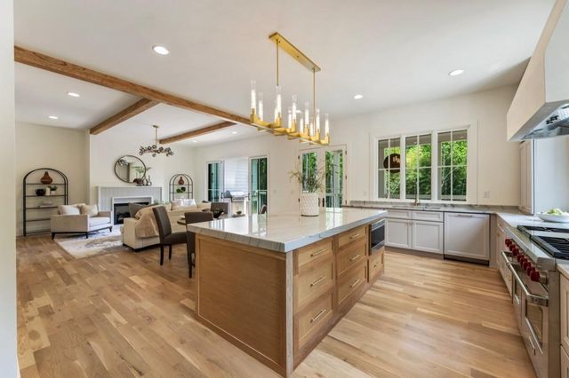 a large white kitchen with a large window
