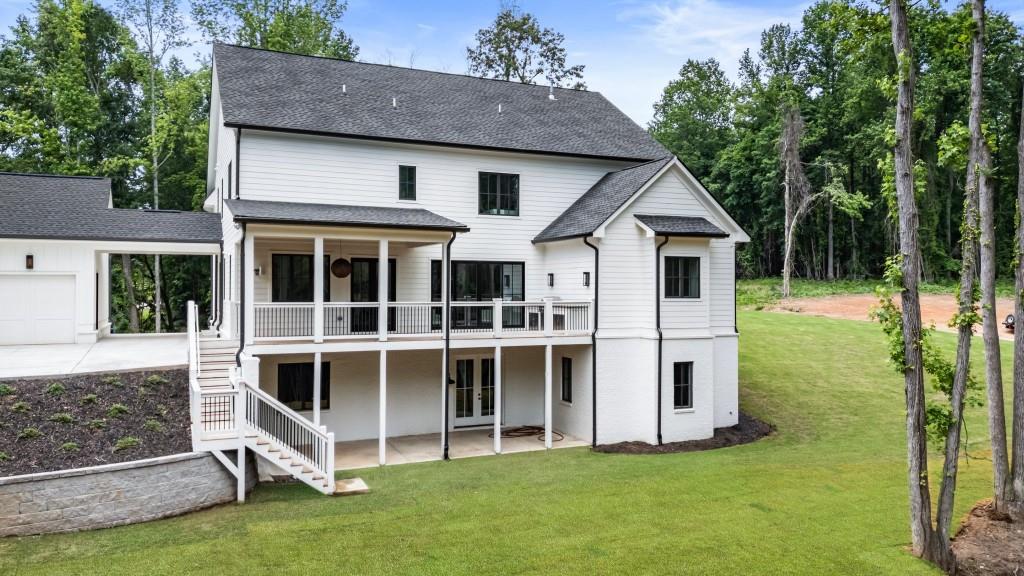 2000 Birmingham Road Milton, GA 30004 - Photo 39 of 42 a big white house with a big yard and large trees