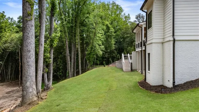 a view of a backyard with large trees
