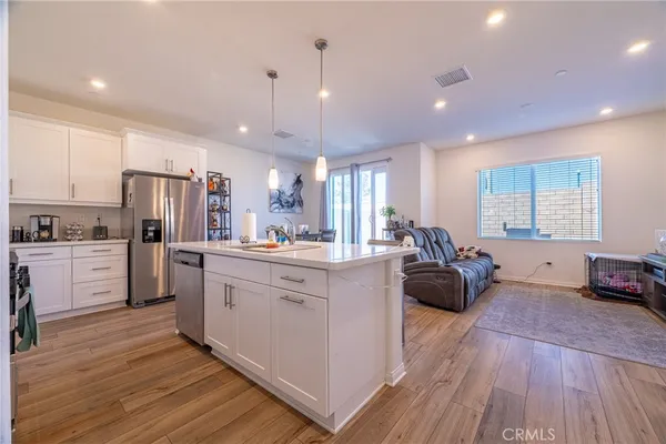 a large white kitchen with stainless steel appliances