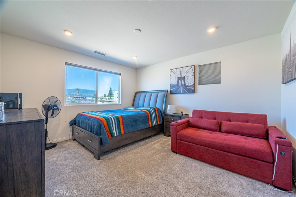 202 Bonita Lane Rialto, CA 92376 - Photo 20 of 43 a bedroom with a bed and a couch
