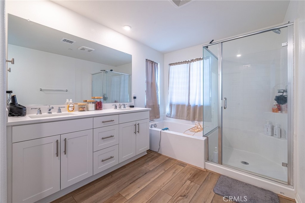 202 Bonita Lane Rialto, CA 92376 - Photo 24 of 43 a bathroom with a double vanity sink a mirror and a shower