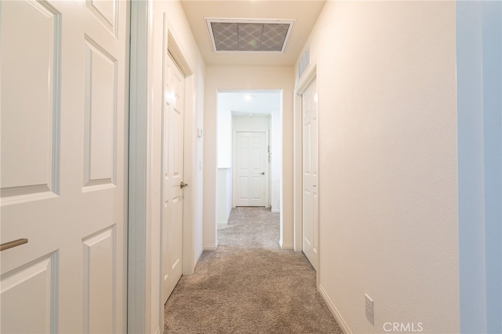 202 Bonita Lane Rialto, CA 92376 - Photo 26 of 43 a view of a hallway with wooden floor