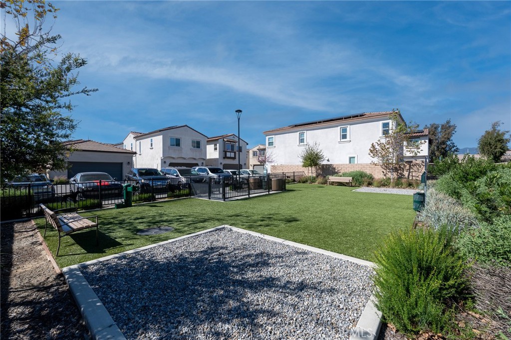202 Bonita Lane Rialto, CA 92376 - Photo 34 of 43 a view of a big house with a big yard and potted plants