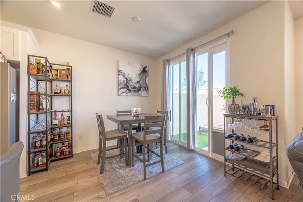 a dining room with furniture and wooden floor