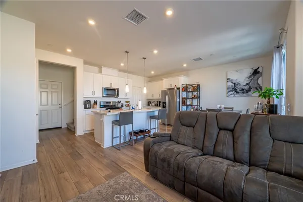 a living room with furniture and kitchen view
