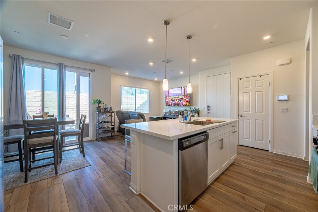 202 Bonita Lane Rialto, CA 92376 - Photo 10 of 43 a kitchen with a stove and wooden floor