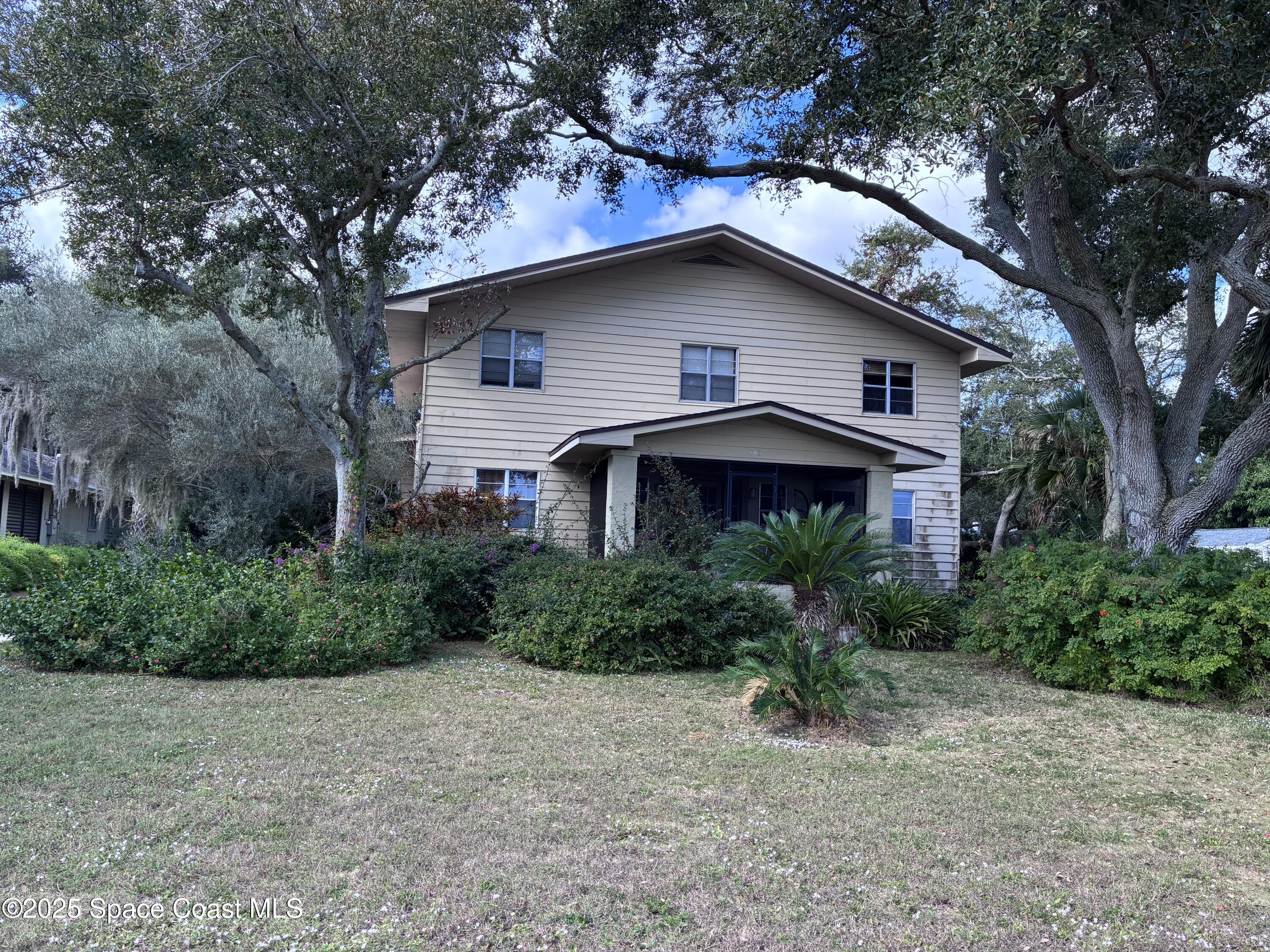 803 Rockledge Drive, Unit 2 Rockledge, FL 32955 - Photo 2 of 15 a house with trees in the background