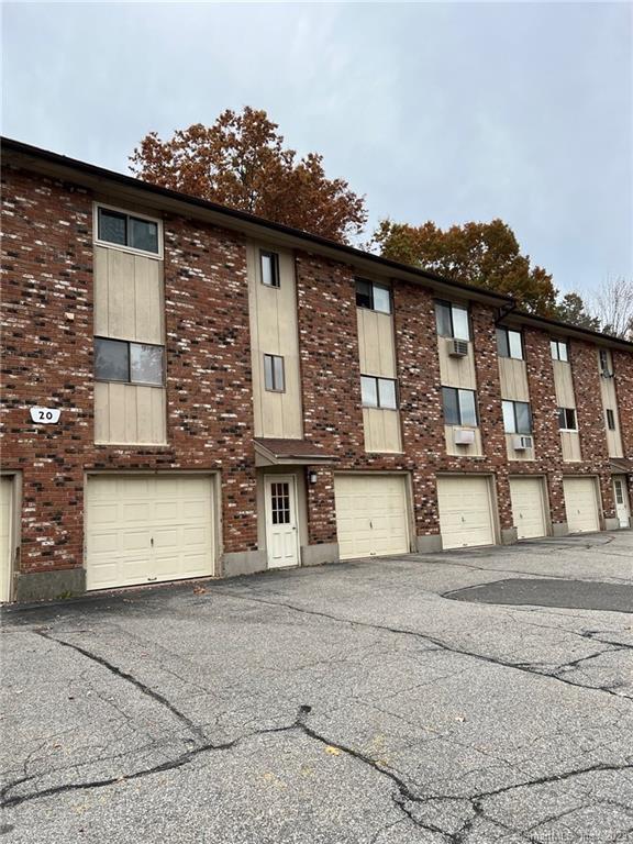 20 Kay Lane, Unit J Waterbury, CT 06708 - Photo 1 of 1 a front view of a house with a yard and garage