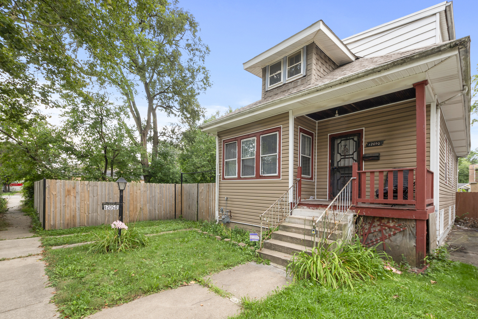 12050 South Yale Avenue Chicago, IL 60628 - Photo 2 of 24 front view of a house with a yard