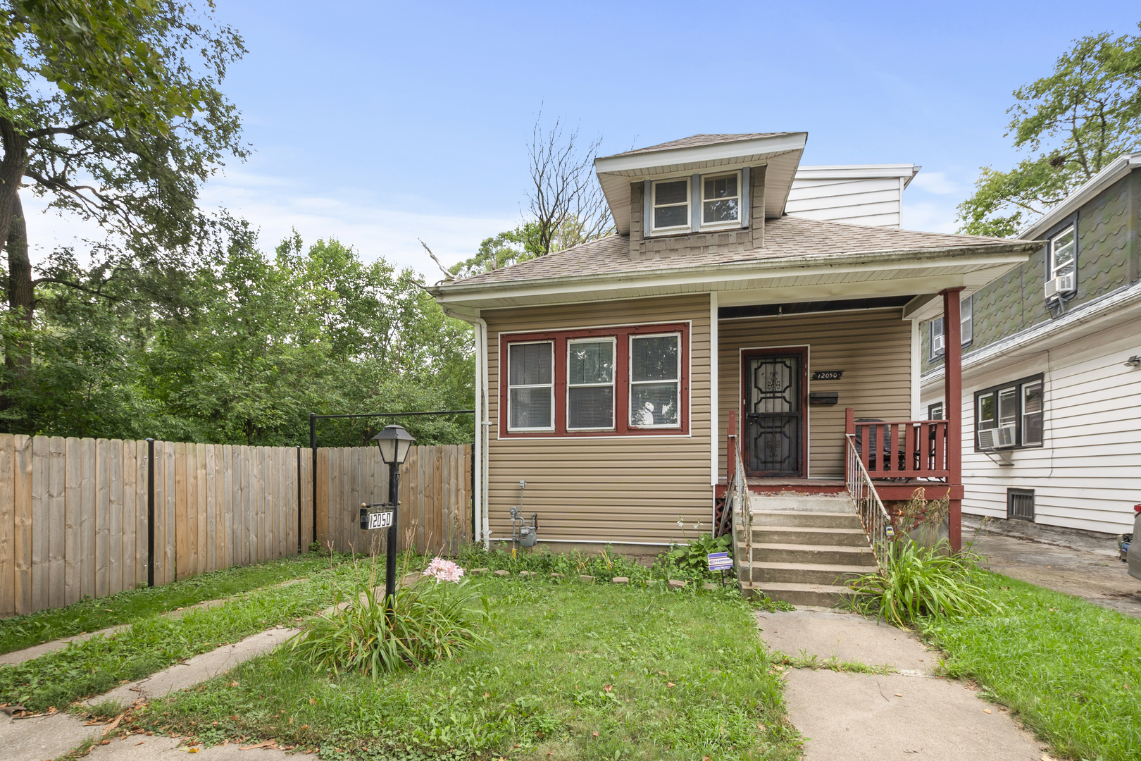 12050 South Yale Avenue Chicago, IL 60628 - Photo 3 of 24 a front view of a house with garden