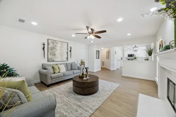 a living room with furniture and a chandelier