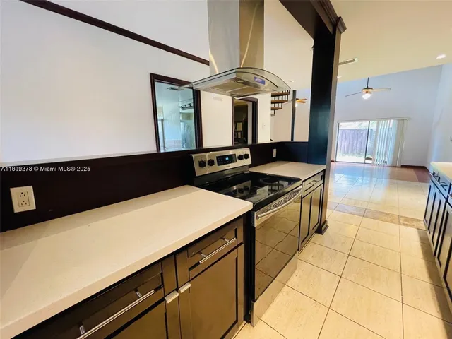 a kitchen with a sink and a stove top oven