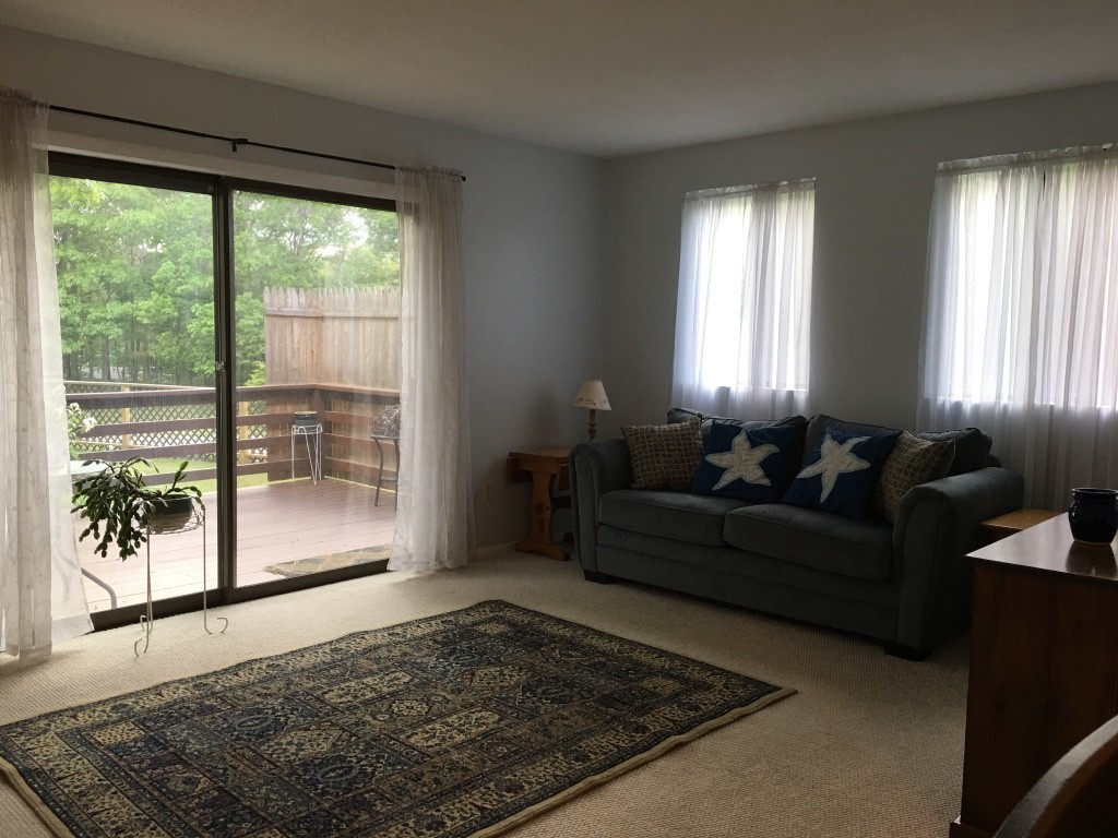 1 Round House Road, Unit 1 Bourne, MA 02532 - Photo 5 of 11 a living room with furniture and a rug