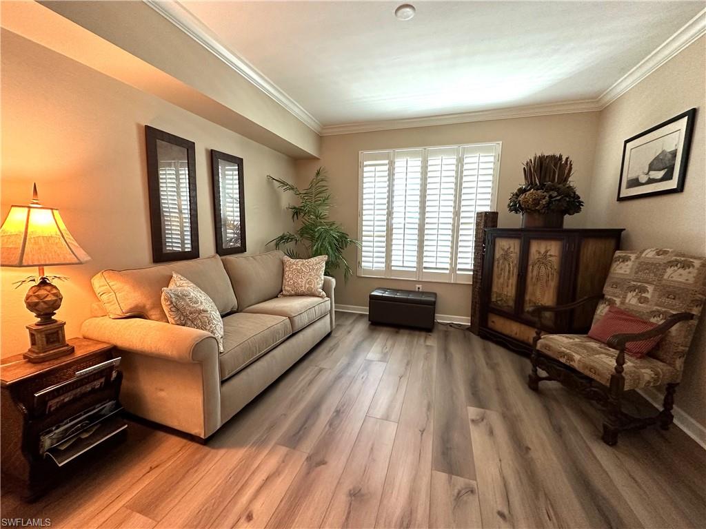 325 Dunes Boulevard, Unit 306 Naples, FL 34110 - Photo 3 of 40 a living room with furniture and a wooden floor
