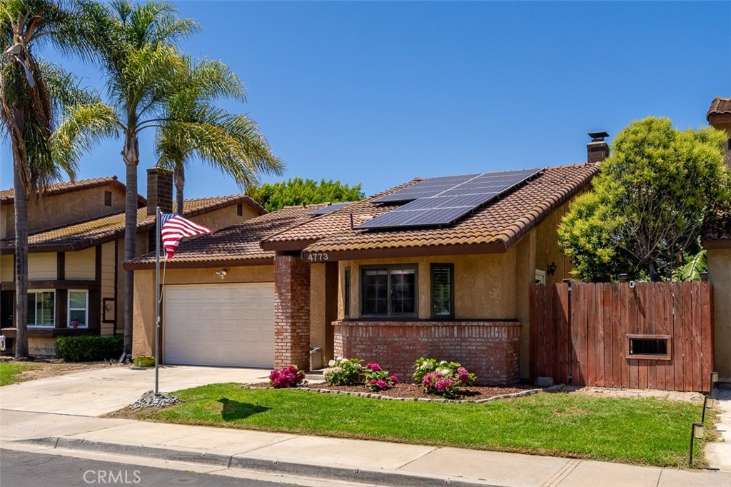 4773 Adler Way Oceanside, CA 92057 - Photo 1 of 29 a front view of a house with a garden