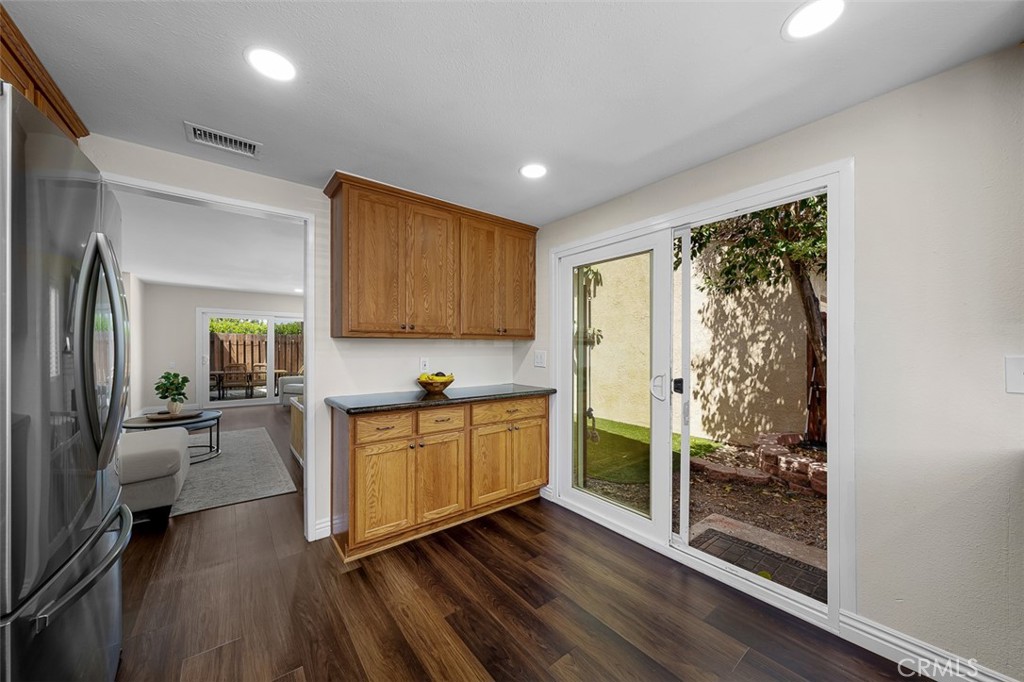 4773 Adler Way Oceanside, CA 92057 - Photo 11 of 29 a kitchen with wooden floors and white stainless steel appliances