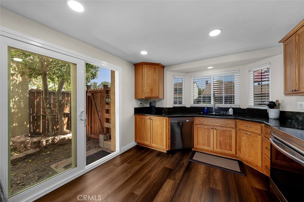 4773 Adler Way Oceanside, CA 92057 - Photo 13 of 29 a large kitchen with granite countertop a large window and stainless steel appliances