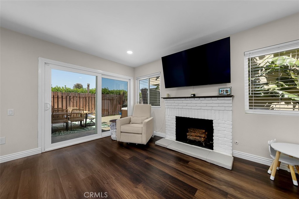 4773 Adler Way Oceanside, CA 92057 - Photo 17 of 29 a living room with furniture a flat screen tv and a fireplace