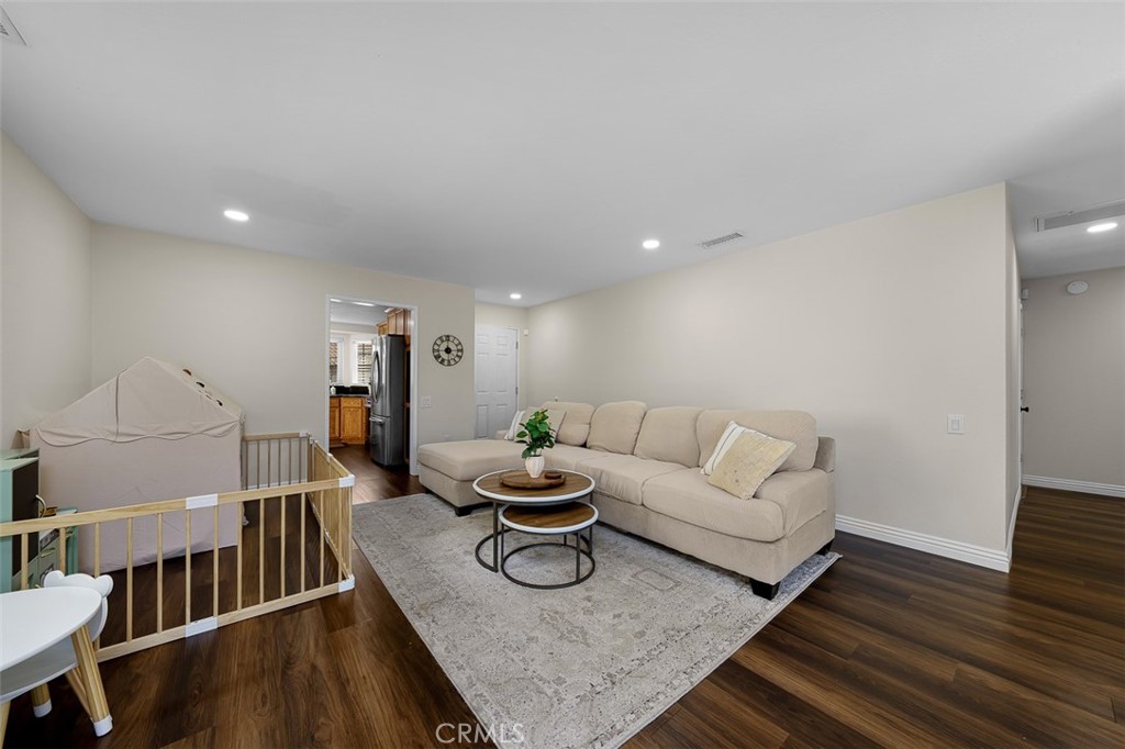 4773 Adler Way Oceanside, CA 92057 - Photo 19 of 29 a living room with furniture and a wooden floor