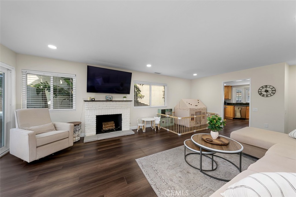 4773 Adler Way Oceanside, CA 92057 - Photo 2 of 29 a living room with furniture flat screen tv and a fireplace