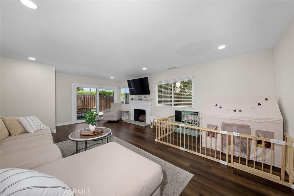 4773 Adler Way Oceanside, CA 92057 - Photo 9 of 29 a living room with fireplace furniture and a flat screen tv