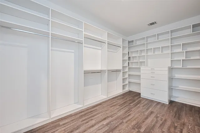 a view of walk in closet with empty racks